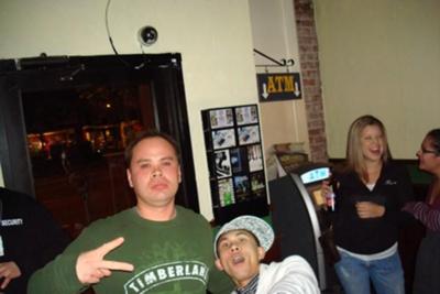 Look closely at door exit, left of Alex (green Shirt)
